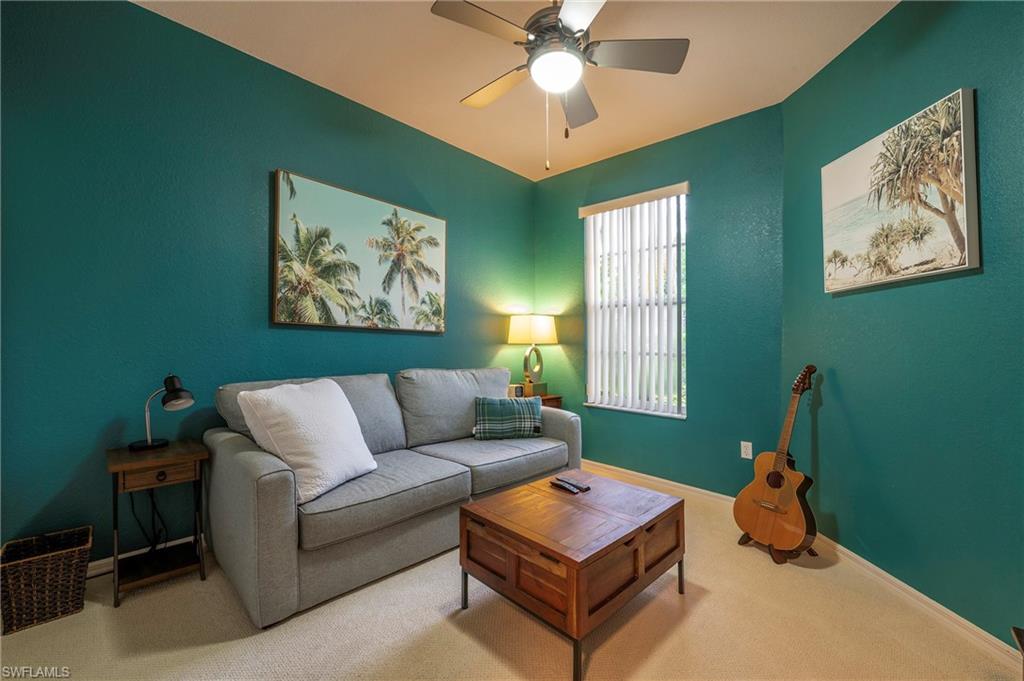 4675 Winged Foot Court, Unit 102 Naples, FL 34114 - Photo 12 of 31 a living room with furniture and a window