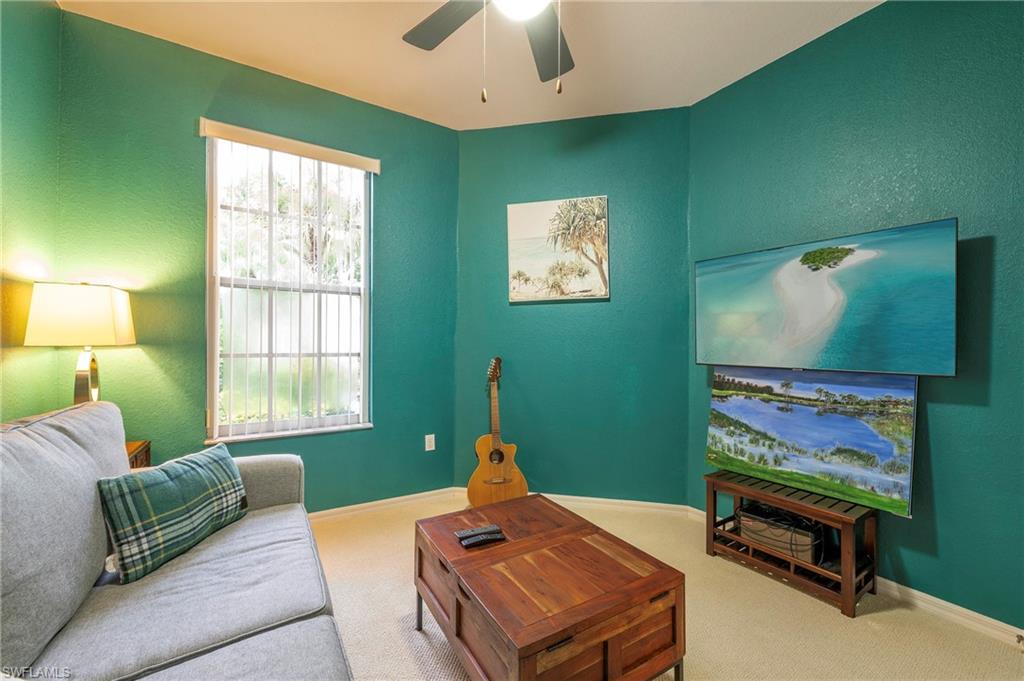 4675 Winged Foot Court, Unit 102 Naples, FL 34114 - Photo 13 of 31 a living room with furniture and a window
