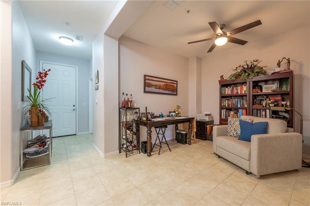 4675 Winged Foot Court, Unit 102 Naples, FL 34114 - Photo 16 of 31 a living room with furniture a chandelier and a dining table