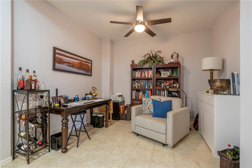 4675 Winged Foot Court, Unit 102 Naples, FL 34114 - Photo 17 of 31 a living room with furniture and a flat screen tv