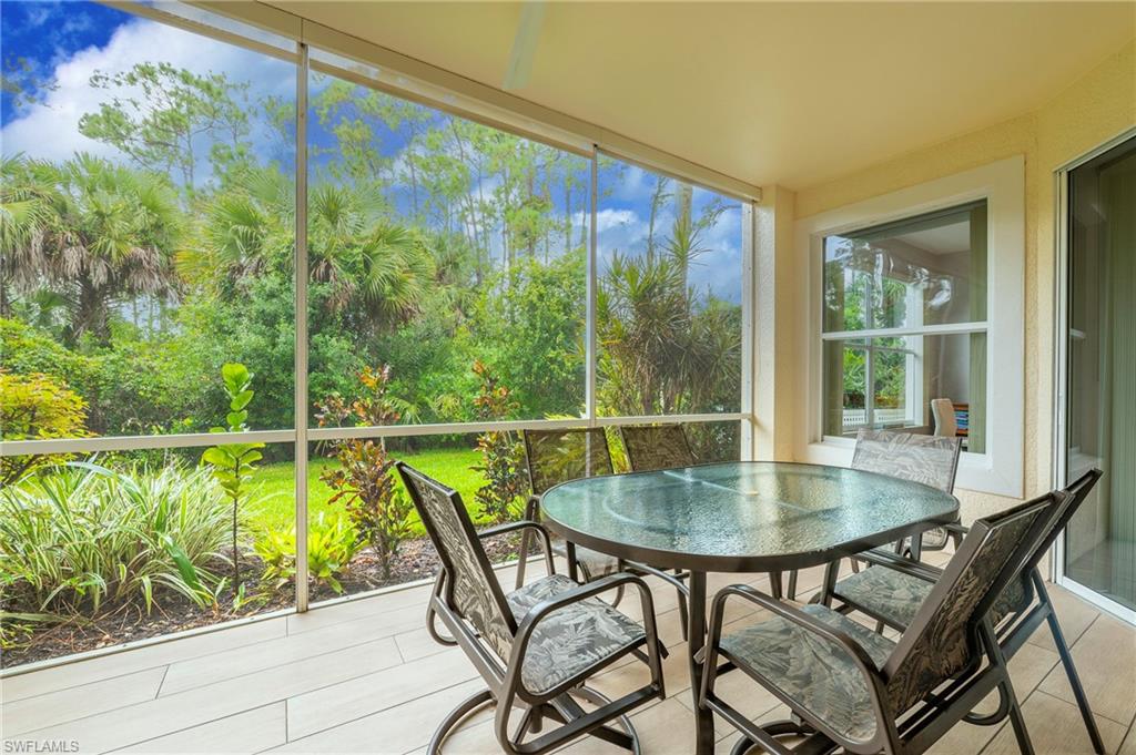 4675 Winged Foot Court, Unit 102 Naples, FL 34114 - Photo 21 of 31 a view of a dining room with furniture window and outside view