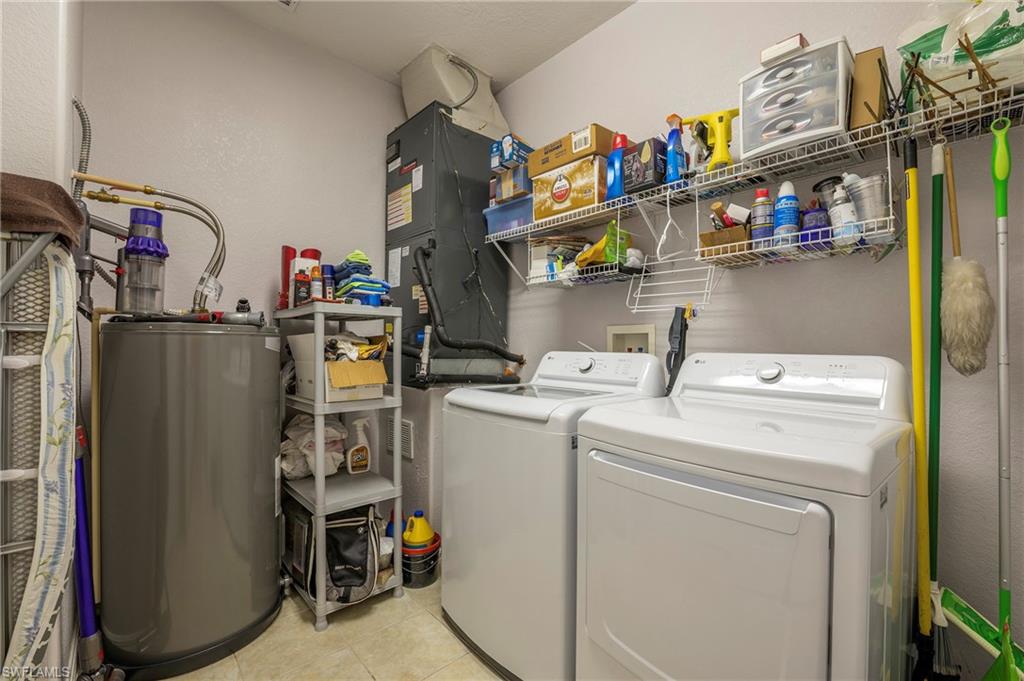 4675 Winged Foot Court, Unit 102 Naples, FL 34114 - Photo 22 of 31 a storage room with washer and dryer