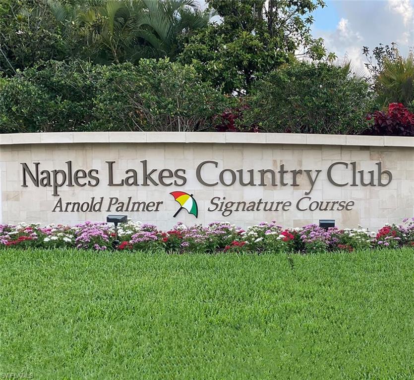 4675 Winged Foot Court, Unit 102 Naples, FL 34114 - Photo 23 of 31 a sign on the side of the wall