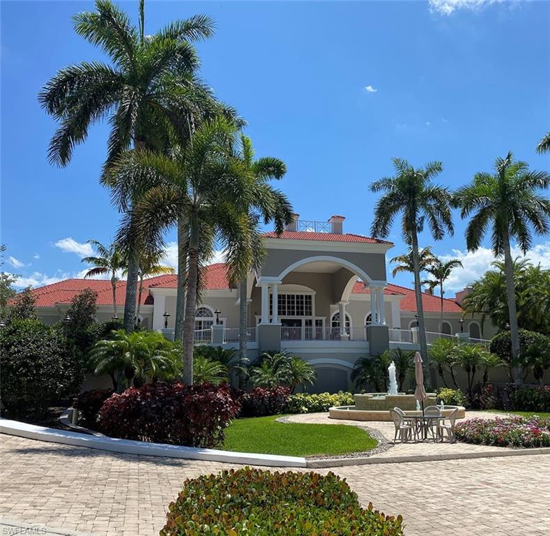 4675 Winged Foot Court, Unit 102 Naples, FL 34114 - Photo 24 of 31 a front view of house with yard and green space