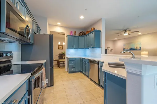 a kitchen with stainless steel appliances granite countertop a sink and cabinets
