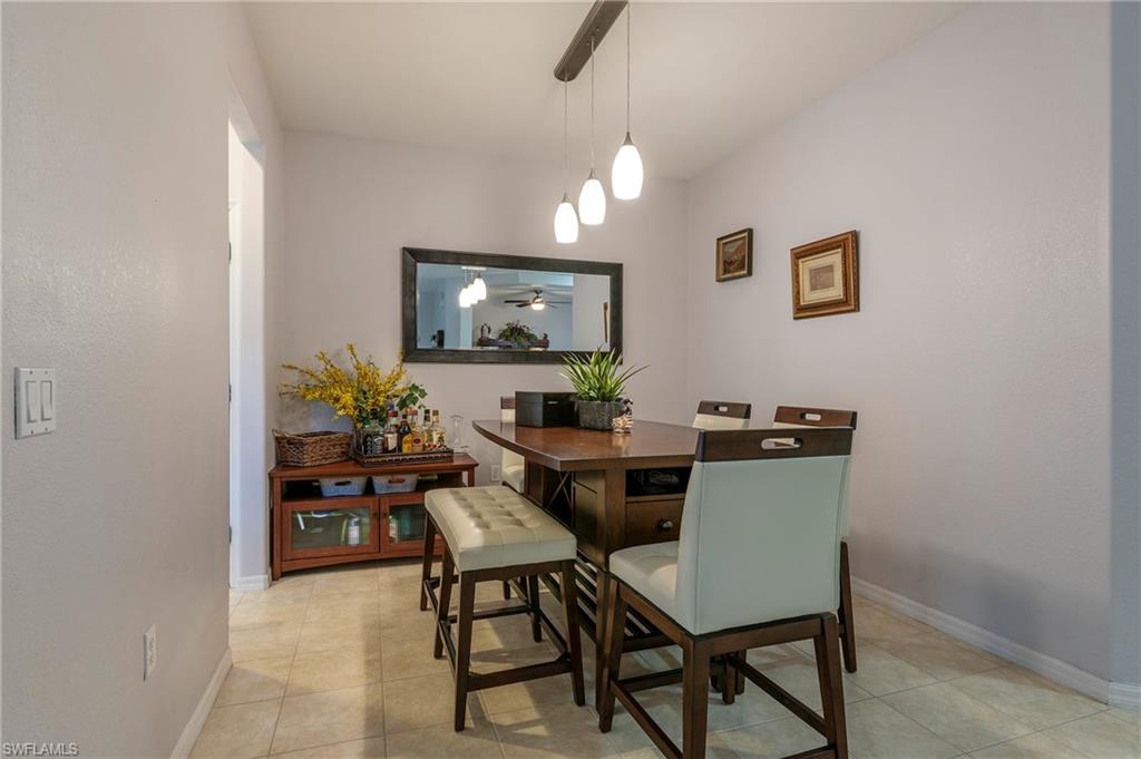 4675 Winged Foot Court, Unit 102 Naples, FL 34114 - Photo 4 of 31 a view of a dining room with furniture