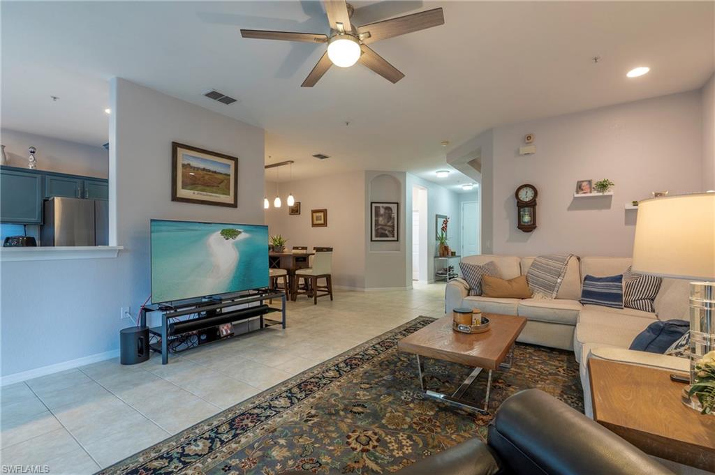 4675 Winged Foot Court, Unit 102 Naples, FL 34114 - Photo 5 of 31 a living room with furniture and a flat screen tv