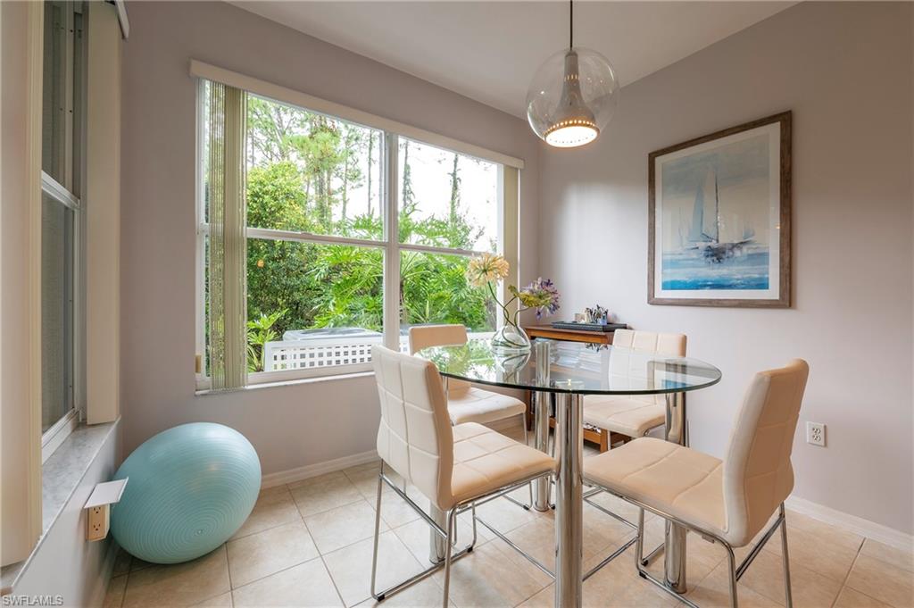 4675 Winged Foot Court, Unit 102 Naples, FL 34114 - Photo 7 of 31 a dining room with furniture and window