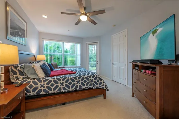 a bedroom with furniture and flat screen tv