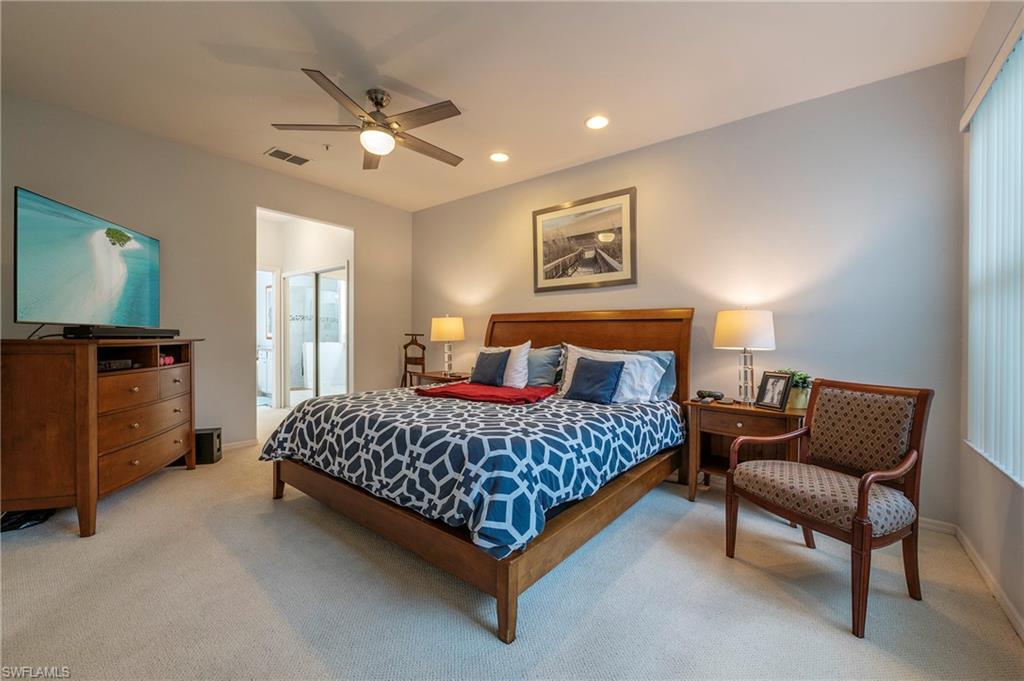 4675 Winged Foot Court, Unit 102 Naples, FL 34114 - Photo 9 of 31 a bedroom with a bed and dresser