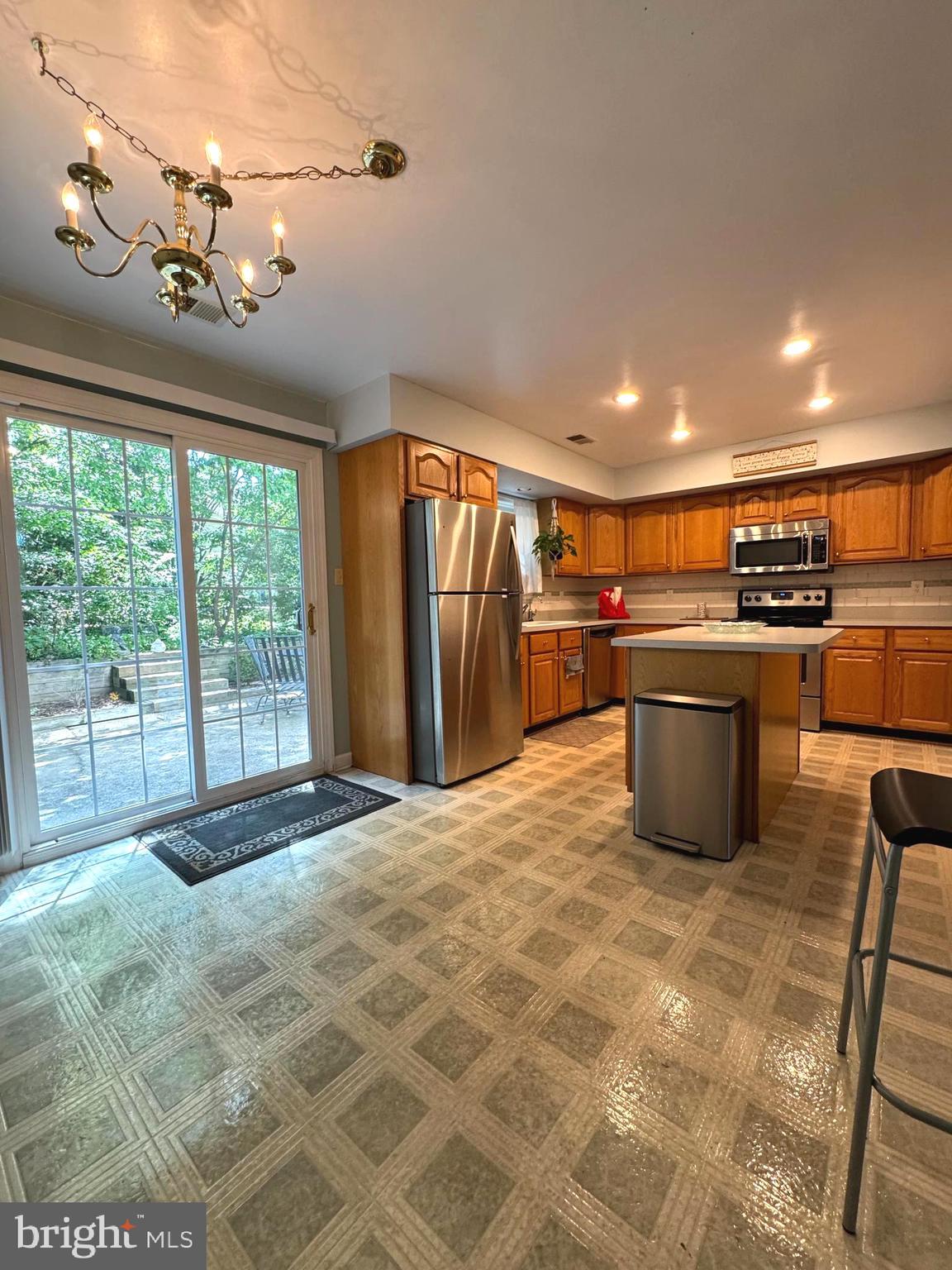 652 Currant Court, Unit 652 La Plata, MD 20646 - Photo 12 of 50 a large kitchen with stainless steel appliances granite countertop a stove oven and a refrigerator with cabinets