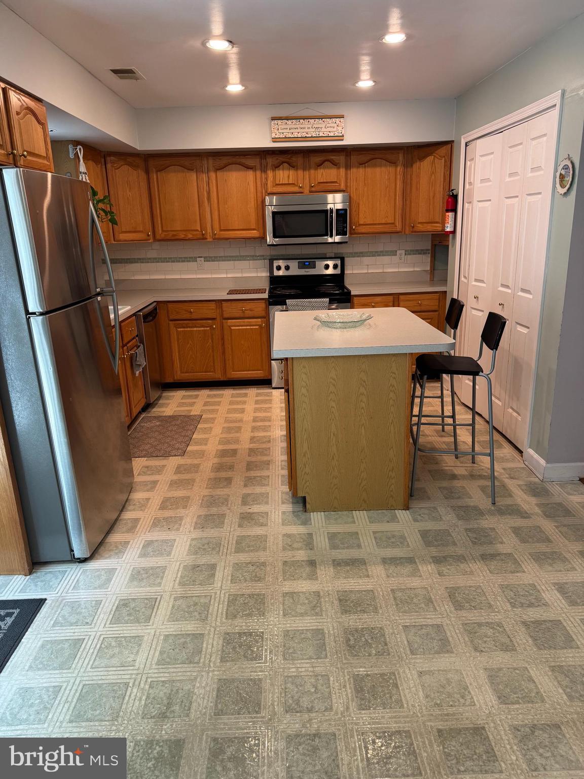 652 Currant Court, Unit 652 La Plata, MD 20646 - Photo 13 of 50 a kitchen with stainless steel appliances granite countertop a refrigerator a stove top oven and a sink
