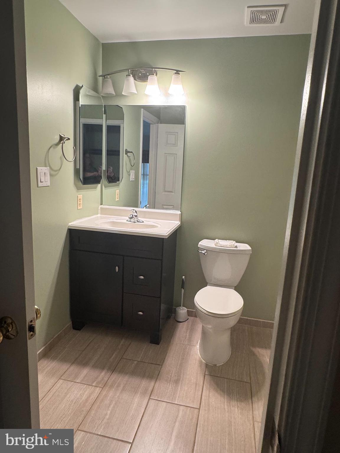 652 Currant Court, Unit 652 La Plata, MD 20646 - Photo 34 of 50 a bathroom with a toilet sink and mirror