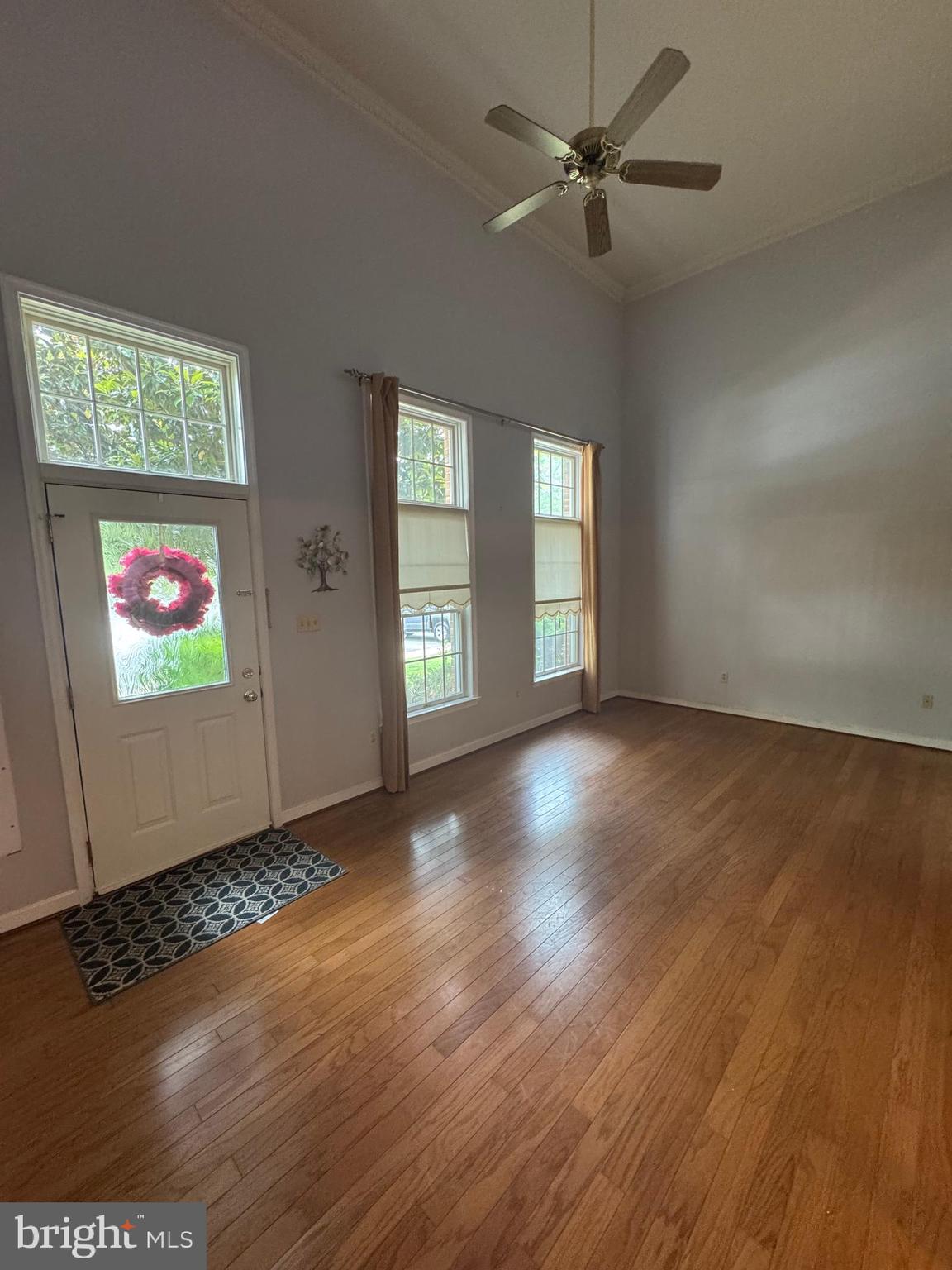 652 Currant Court, Unit 652 La Plata, MD 20646 - Photo 4 of 50 an empty room with wooden floor chandelier fan and windows