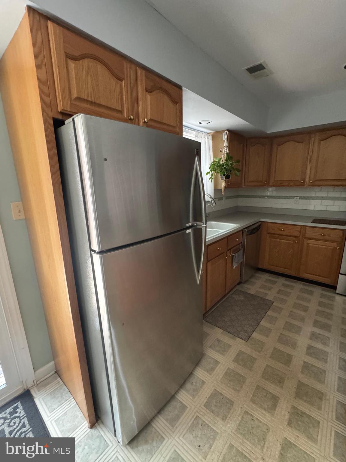 652 Currant Court, Unit 652 La Plata, MD 20646 - Photo 44 of 50 a kitchen with granite countertop a refrigerator and a sink