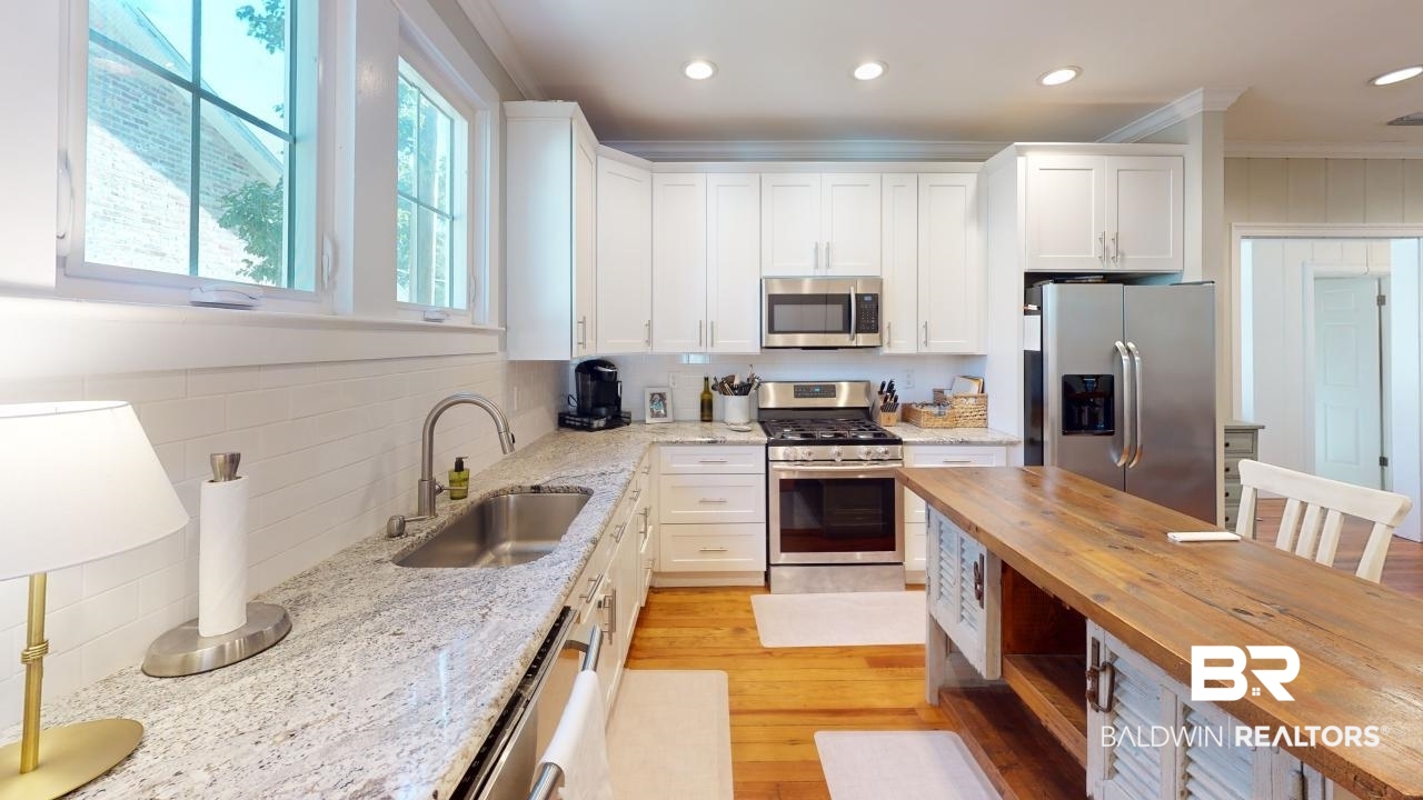 4358 Stein Street Mobile, AL 36608 - Photo 7 of 29 Kitchen with wood counters, appliances with stainless steel finishes, ornamental molding, sink, and white cabinetry