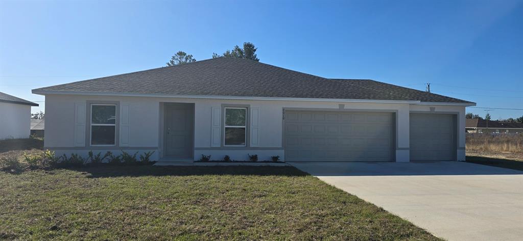 6010 Southwest 128th St Road Ocala, FL 34473 - Photo 1 of 16 a front view of a house with a yard