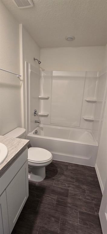 6010 Southwest 128th St Road Ocala, FL 34473 - Photo 13 of 16 a bathroom with a granite countertop toilet a sink and a bathtub