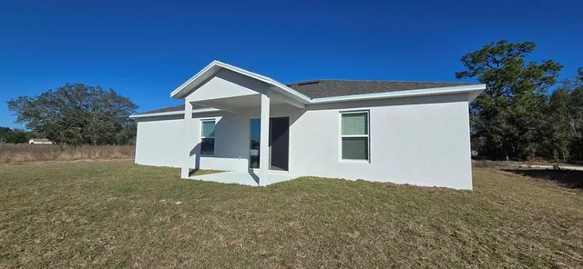a view of backyard with a garden and entertaining space