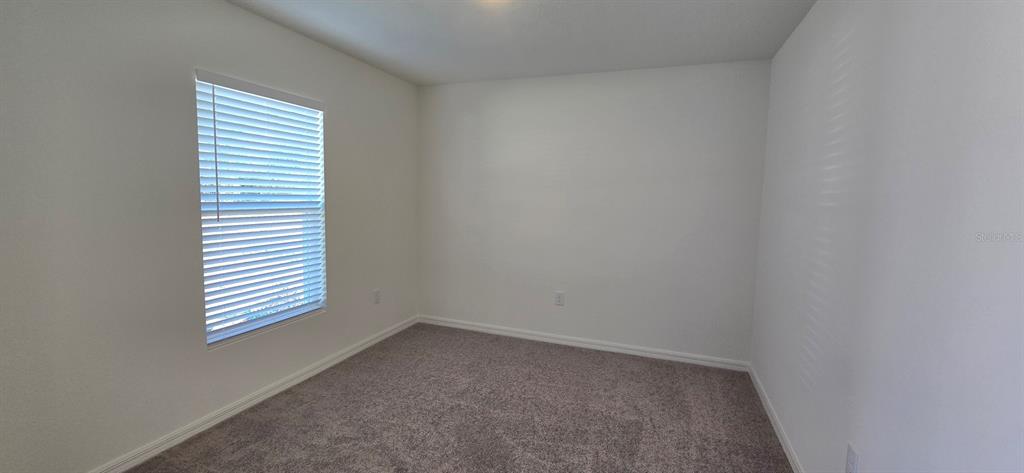 6010 Southwest 128th St Road Ocala, FL 34473 - Photo 8 of 16 an empty room with a window