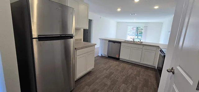 a kitchen with stainless steel appliances granite countertop a sink stove and microwave