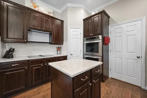 a kitchen with a sink stove and microwave