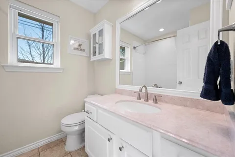 a bathroom with a sink toilet and a mirror