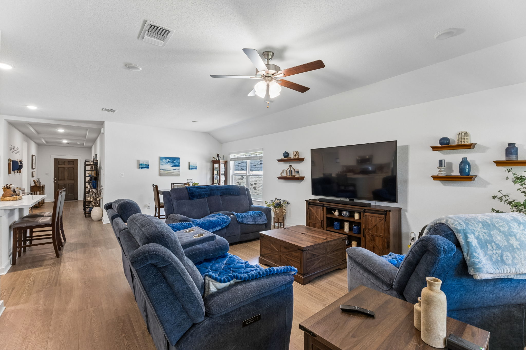 13509 Barn Chime Street Elgin, TX 78621 - Photo 11 of 40 Spacious living area featuring wood-finish flooring, a vaulted ceiling, and recessed lighting