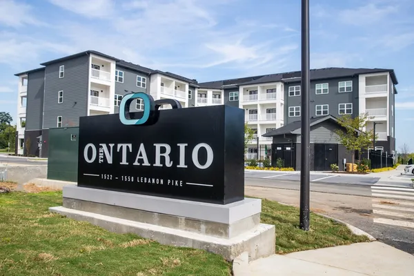 a front view of a building with street sign and entrance