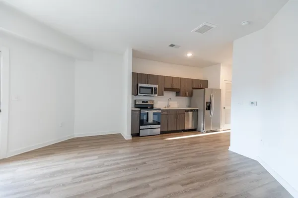 a view of kitchen with stainless steel appliances cabinets a sink and a stove top oven