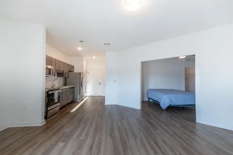 a kitchen with stainless steel appliances a refrigerator and a stove top oven