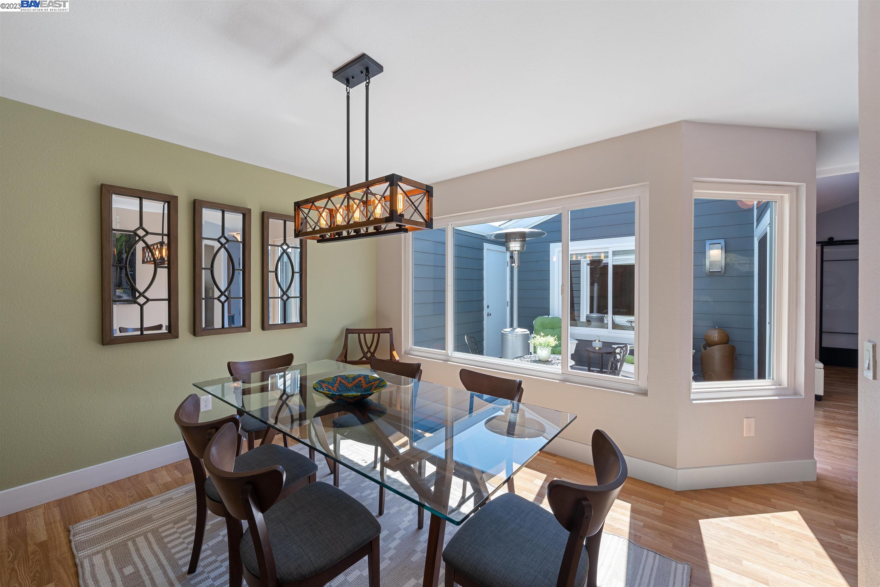 Undisclosed Address Alameda, CA 94502 - Photo 13 of 44 a living room with furniture a window and a chandelier