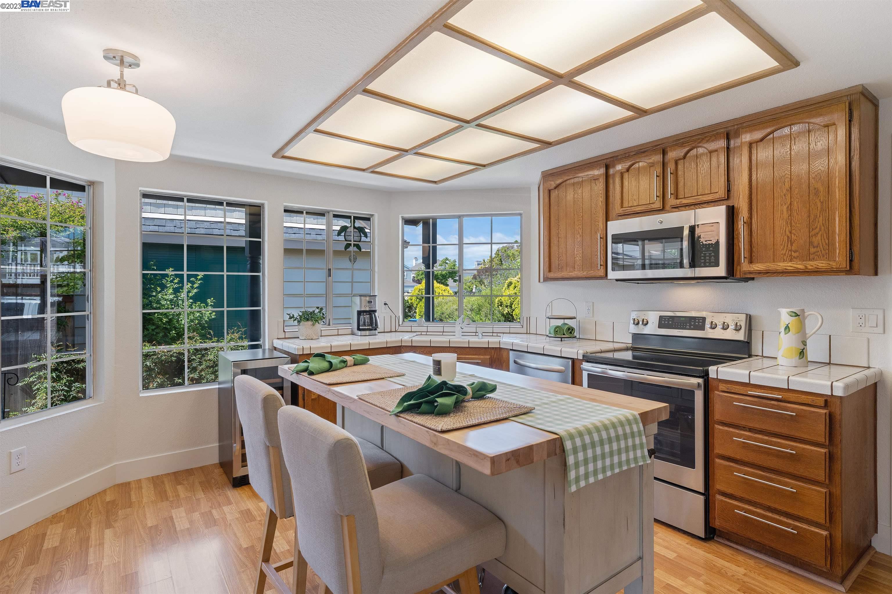 Undisclosed Address Alameda, CA 94502 - Photo 19 of 44 a kitchen with a stove a sink and a microwave