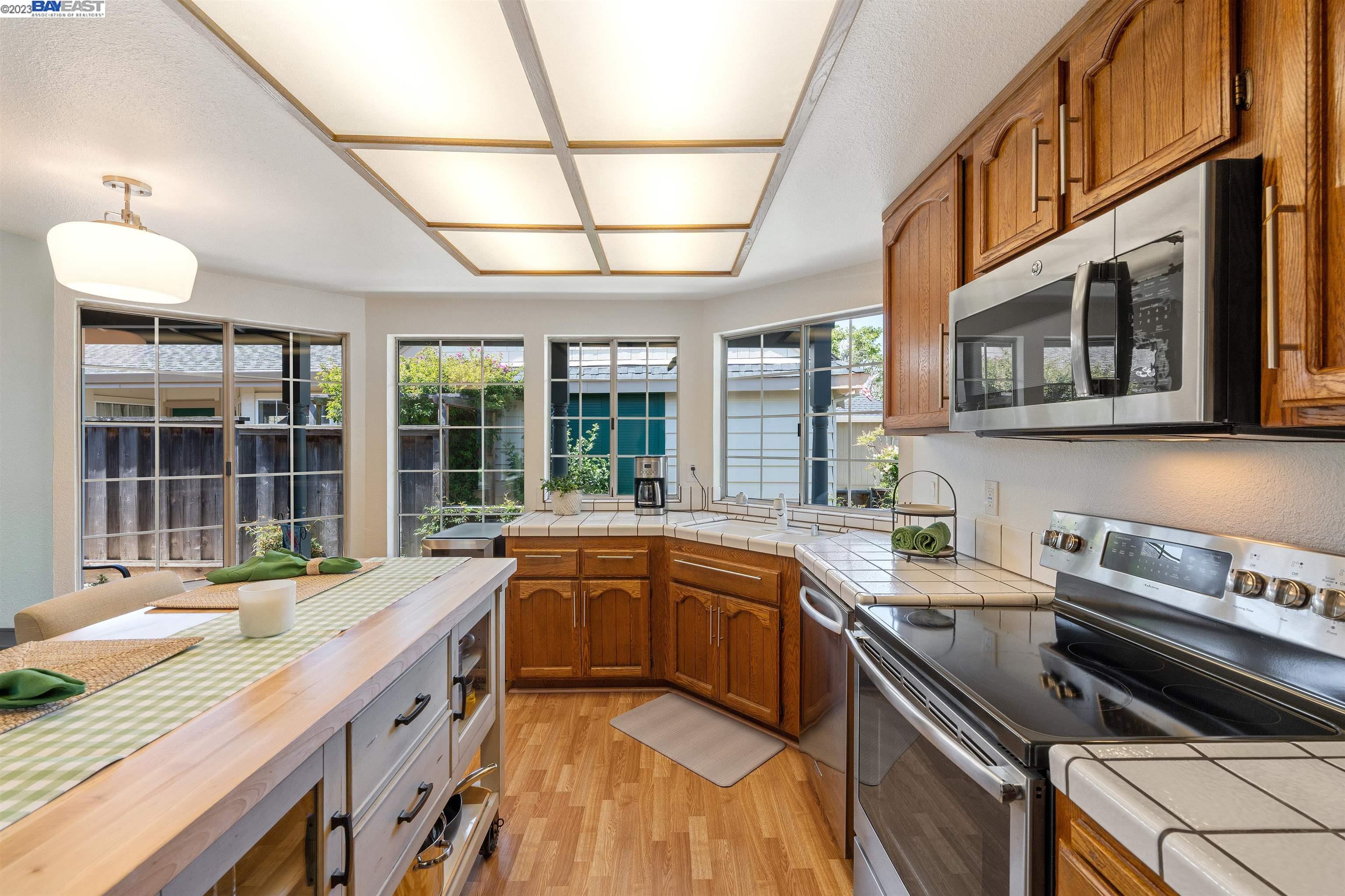 Undisclosed Address Alameda, CA 94502 - Photo 21 of 44 a kitchen with stainless steel appliances granite countertop a sink and stove