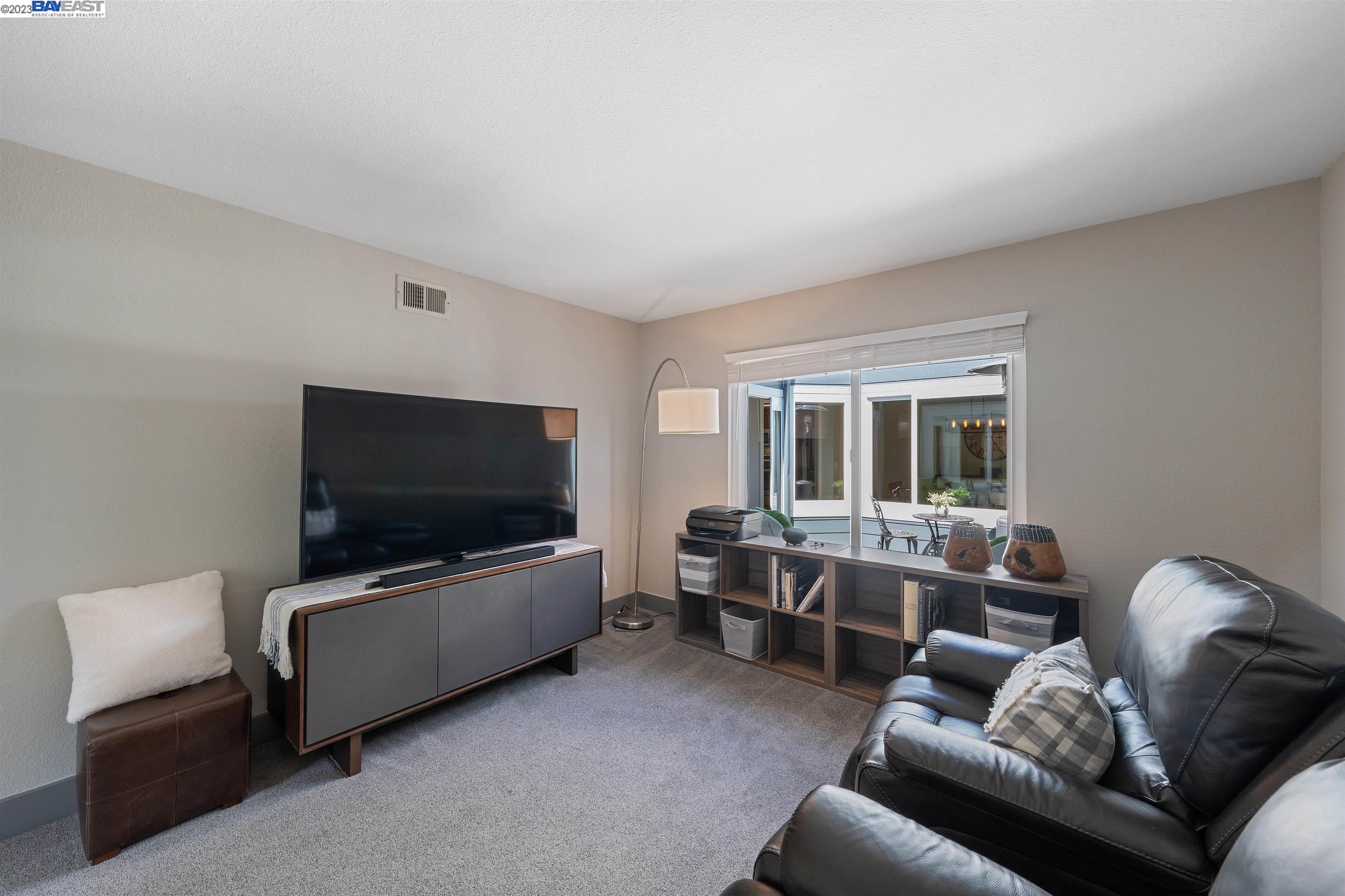 Undisclosed Address Alameda, CA 94502 - Photo 24 of 44 a living room with furniture and a flat screen tv