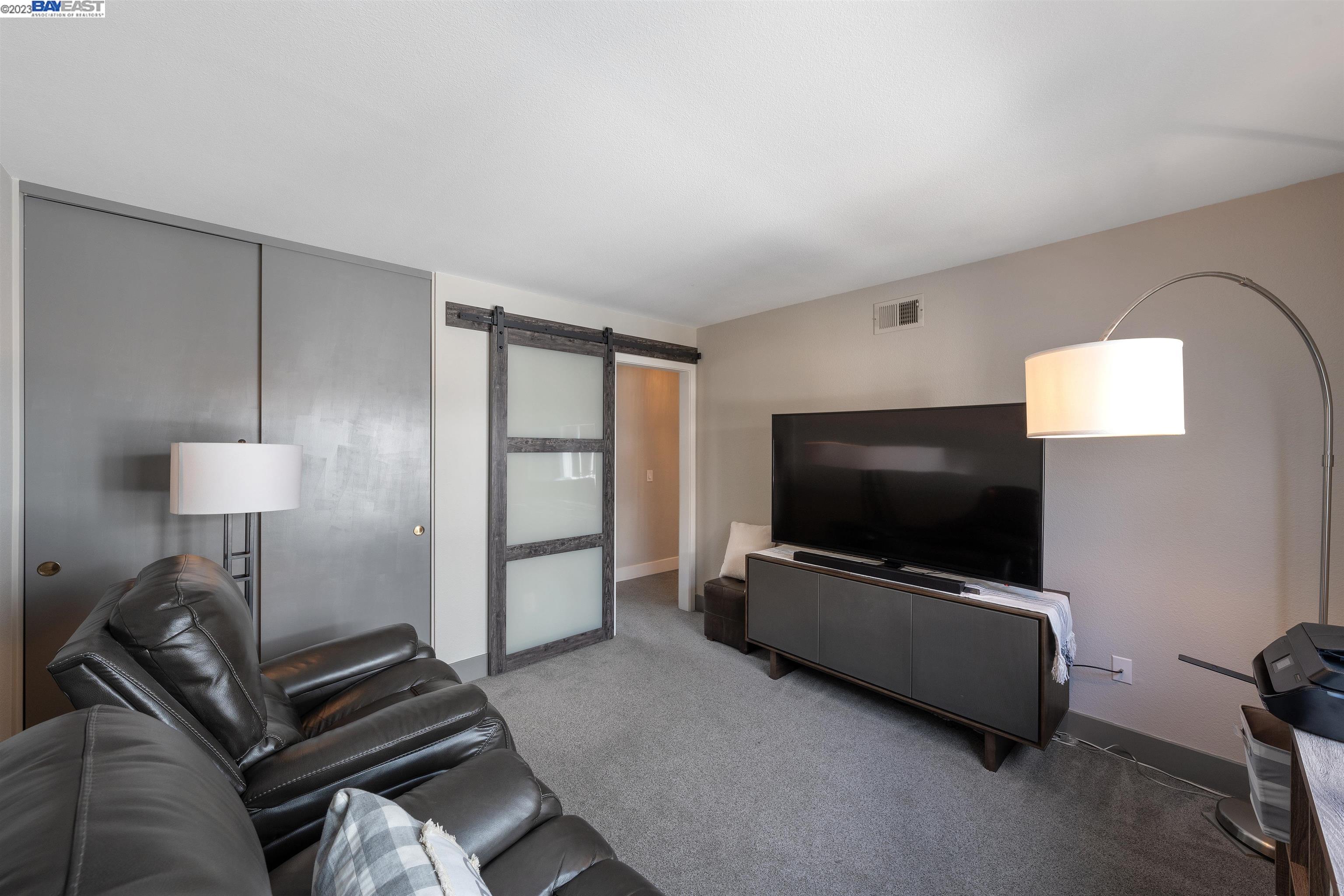 Undisclosed Address Alameda, CA 94502 - Photo 25 of 44 a living room with furniture and a flat screen tv