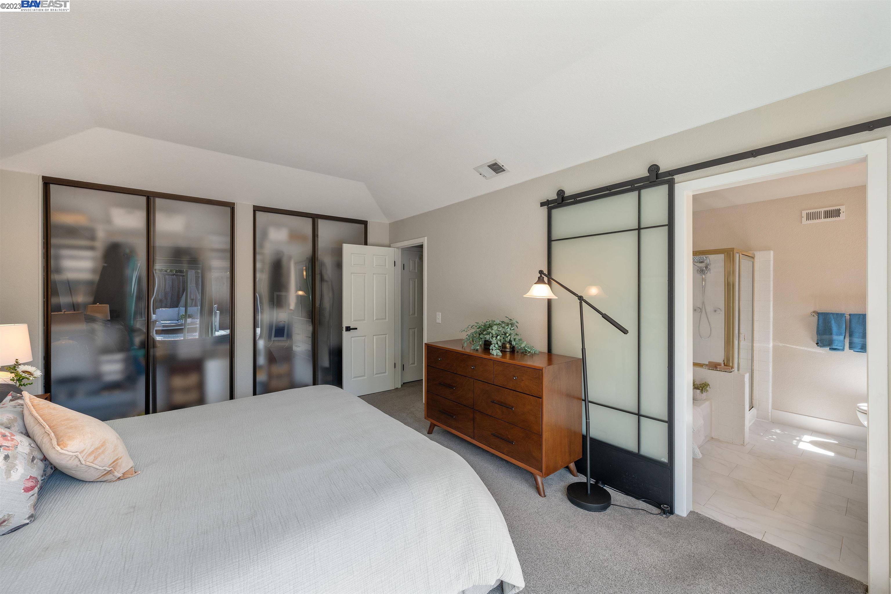 Undisclosed Address Alameda, CA 94502 - Photo 32 of 44 a bedroom with a large bed and wooden floor