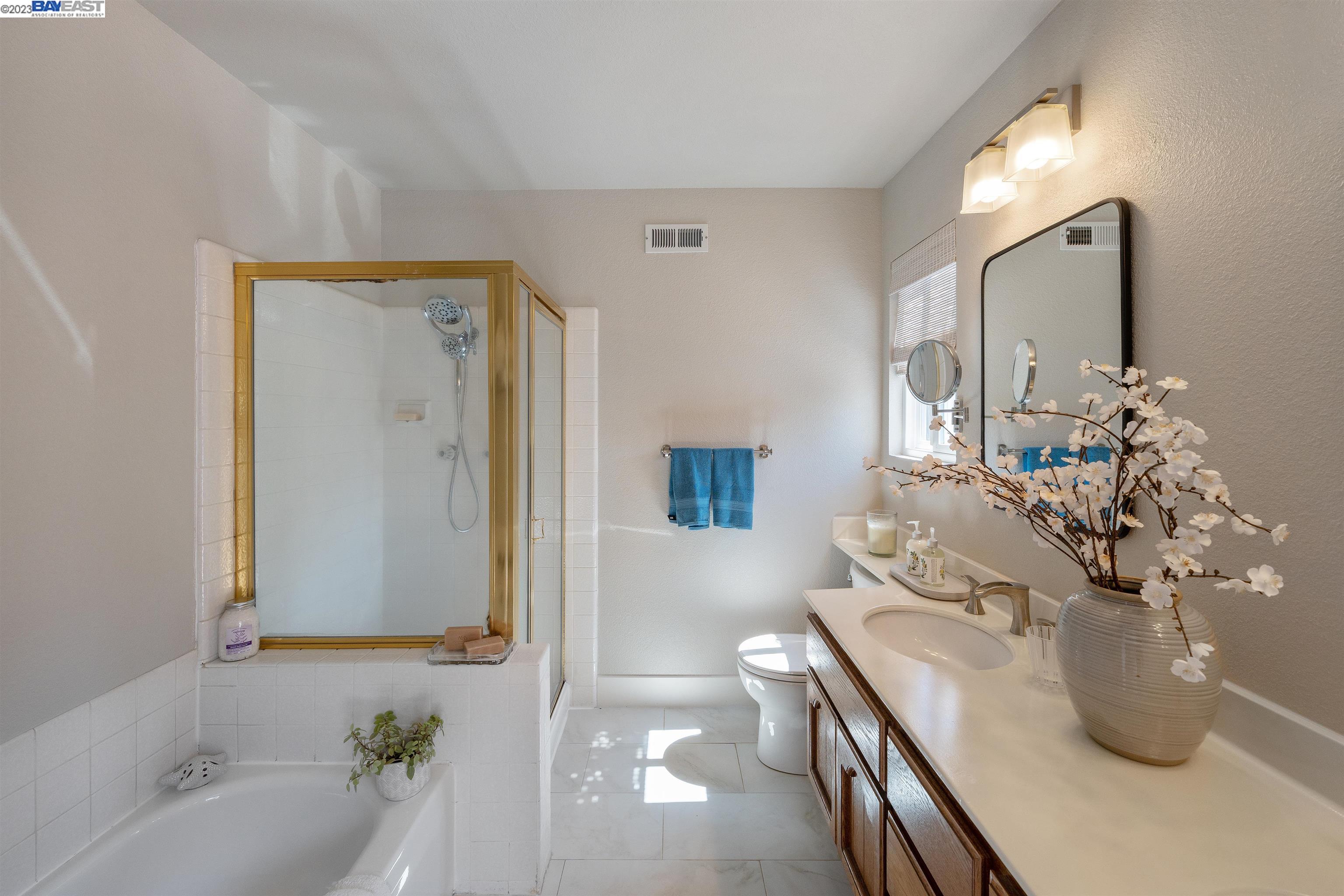 Undisclosed Address Alameda, CA 94502 - Photo 35 of 44 a spacious bathroom with a granite countertop sink a toilet and bathtub