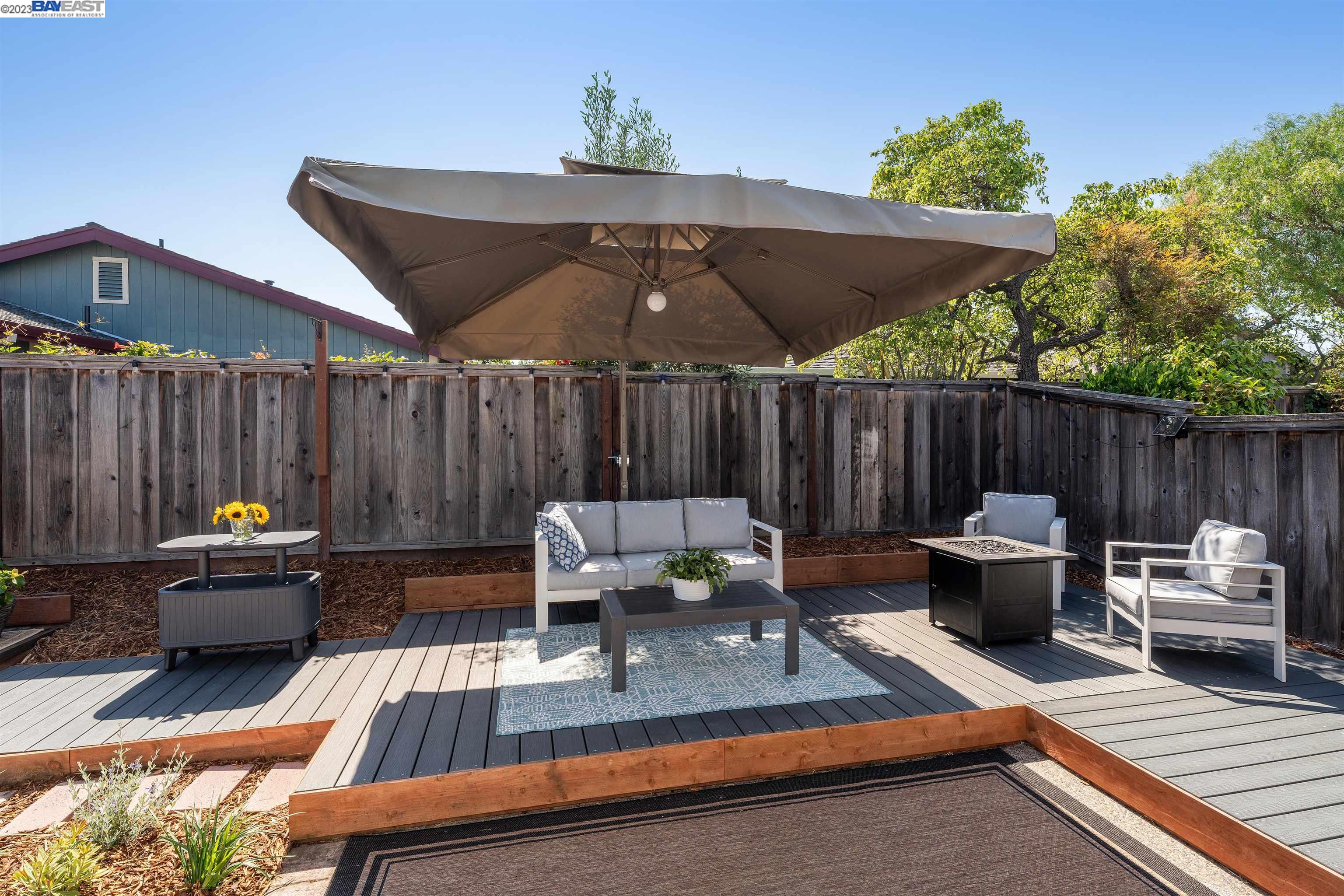 Undisclosed Address Alameda, CA 94502 - Photo 38 of 44 a view of patio with couches a table and chairs with wooden fence