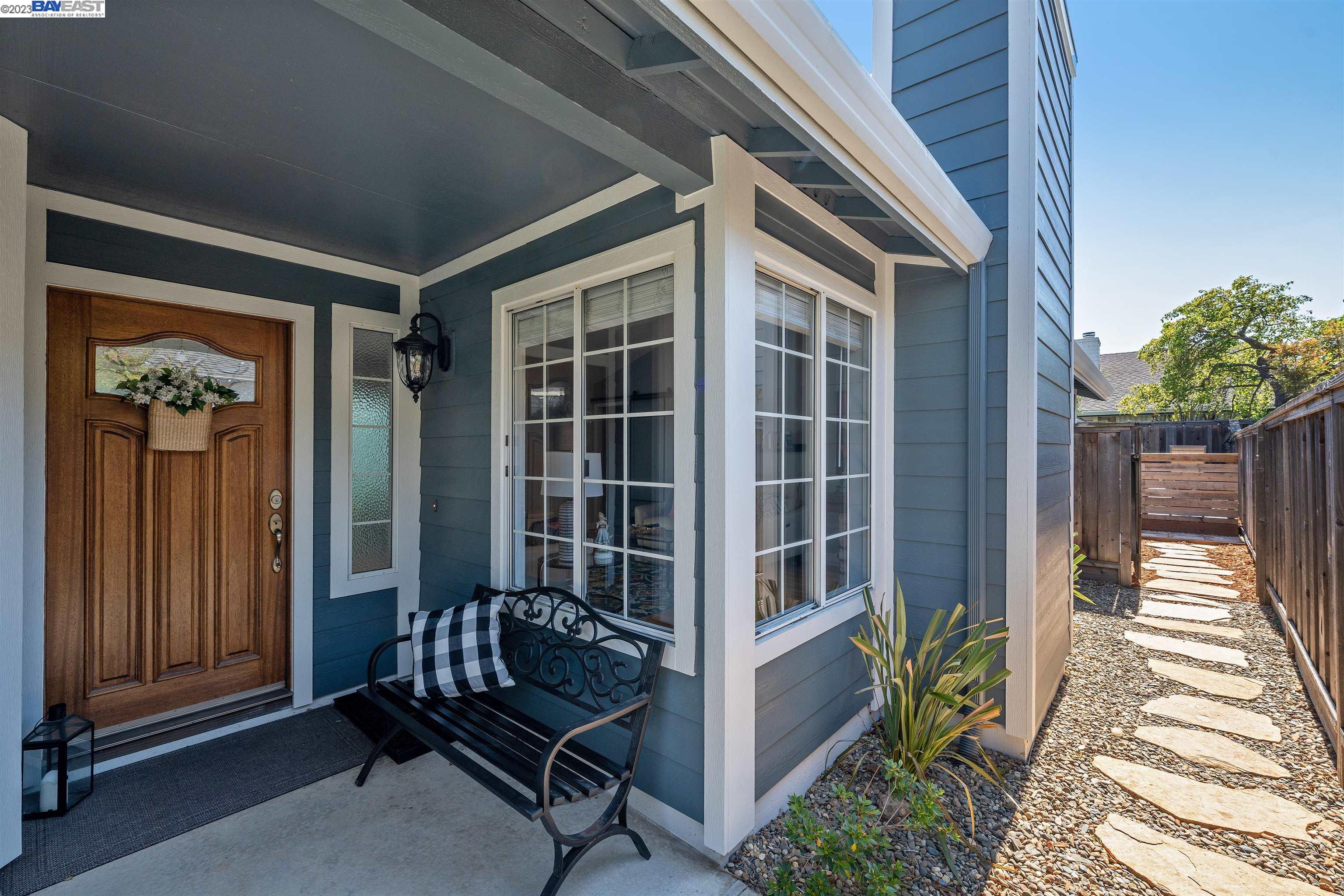 Undisclosed Address Alameda, CA 94502 - Photo 4 of 44 a front view of a house with a chairs and table in patio