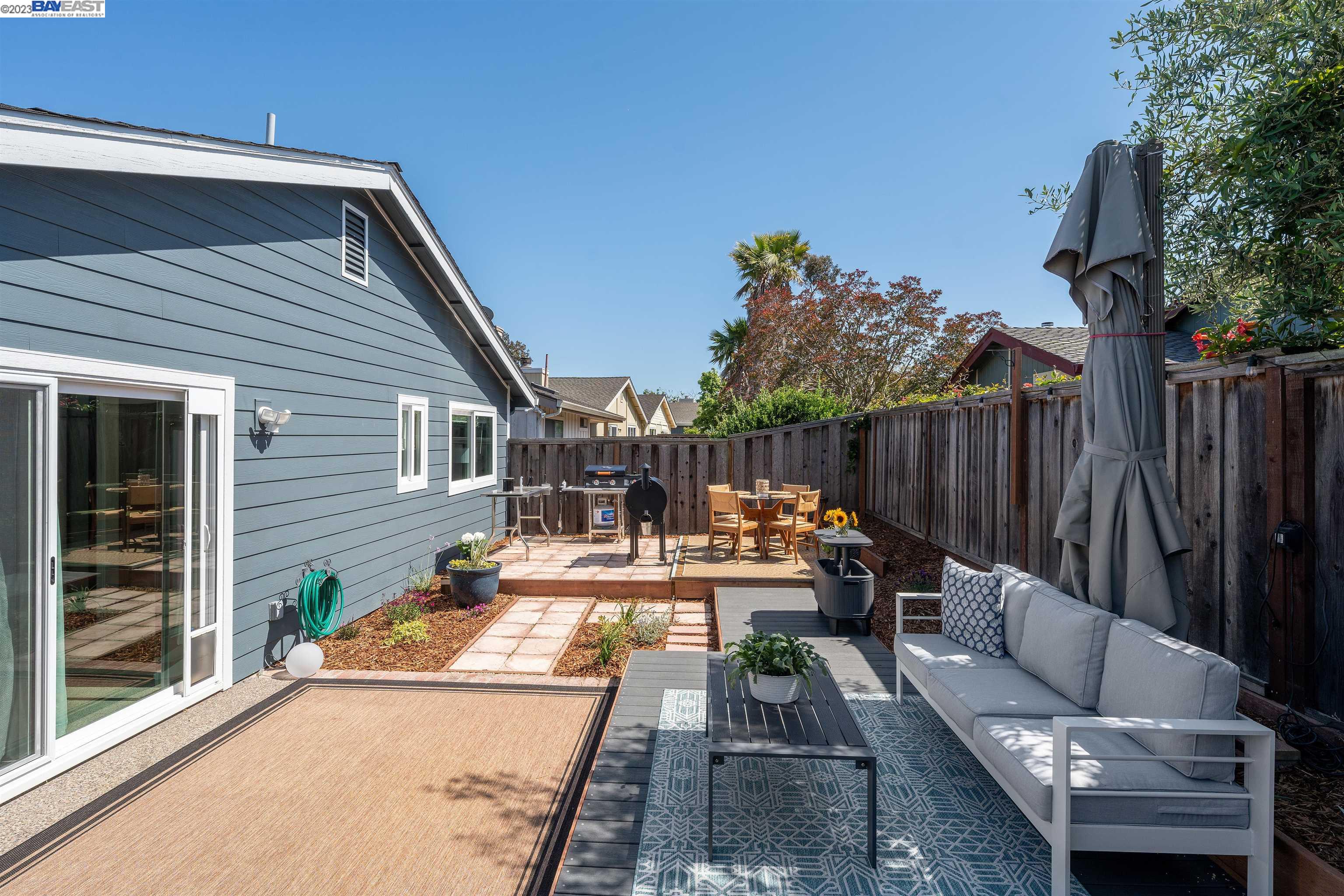 Undisclosed Address Alameda, CA 94502 - Photo 41 of 44 a view of a patio with couches table and chairs with wooden fence