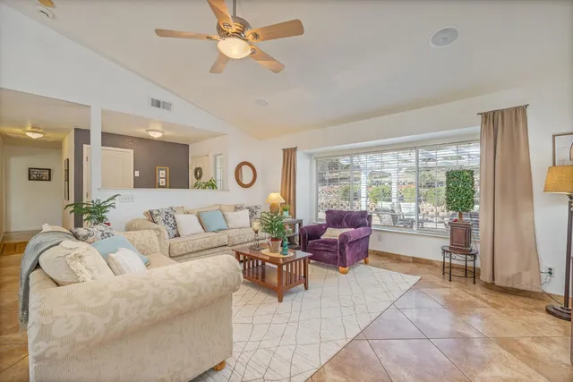 a kitchen with a sink dishwasher a refrigerator and cabinets with wooden floor