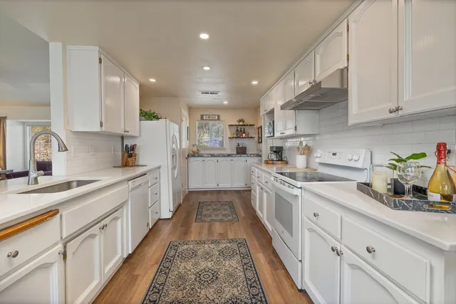 a kitchen with kitchen island a sink and stove