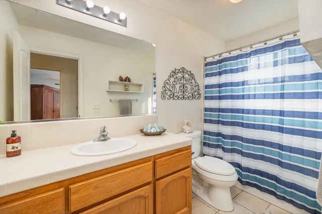 a bathroom with a double vanity sink a mirror and a shower