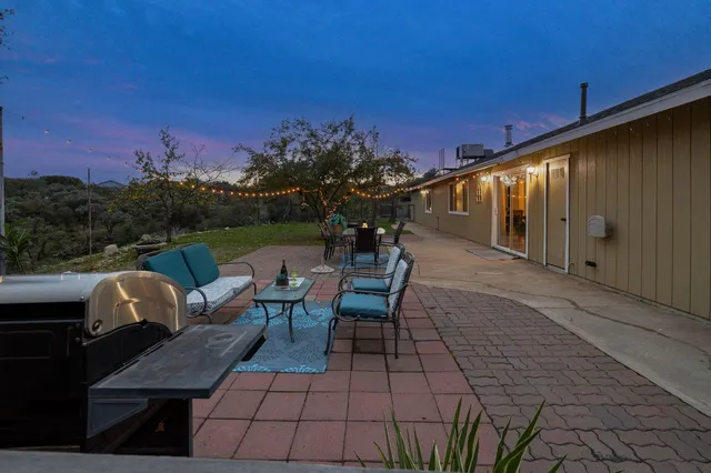 a view of dirt yard with a tree