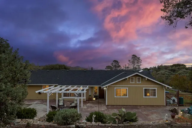 a view of an outdoor space with patio furniture and garden