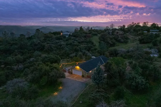 a view of a patio with table and chairs under an umbrella