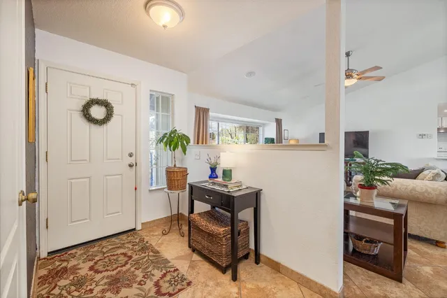 a living room with furniture a flat screen tv and a large window
