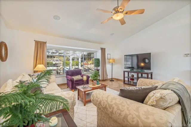 a dining room with furniture a rug and a floor to ceiling window
