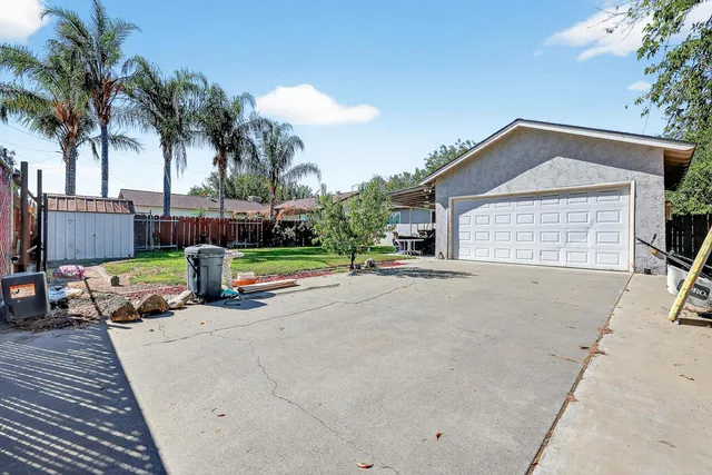 a view of a house with outdoor space and palm trees